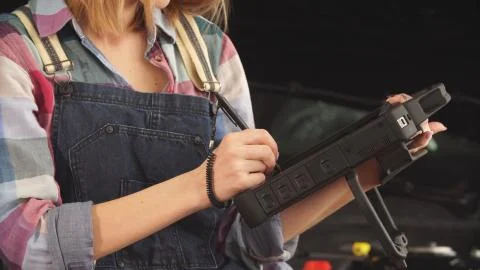 Serious young car mechanic solves engine problems 写真素材