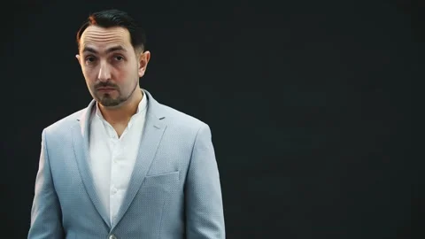 Serious young concentrated man looking to the side then up at the camera, posing Stock Footage 130324571
