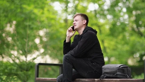 Serious young guy confidently talking on the phone. Stock Footage 201824475