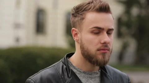 Serious young guy looking on a camera Stock Footage 63469778