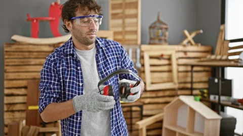 Serious young man, handsome blond carpenter with a beard, decked out in saf.. Stock Footage 263478448
