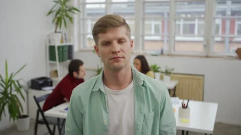 Serious young man posing at office Stock Footage 142159069