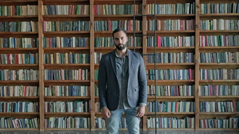 Serious Young Man Standing In The Library. Stock Footage 140222099