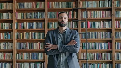 Serious Young Man Standing In The Library. Video stock 140222264