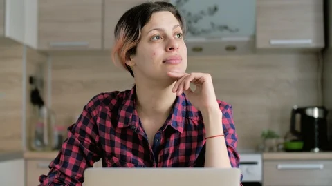 Serious young woman thinking solving problem at home office on laptop Stock Footage 128902155