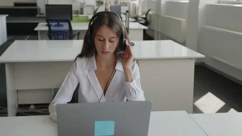 Serious young worker sits and speaks to the customer Video stock 157968440