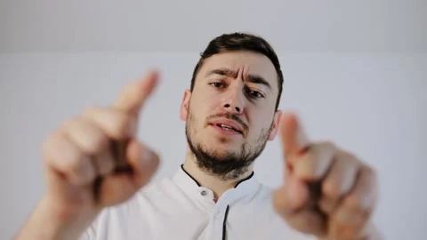 Seriously young man talking to the camera and points his finger at camera Stock Footage 132780812