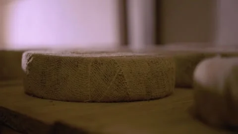 Serra da Canastra Cheese that is being cured in a cellar with rag envolved Stock Footage 258684129