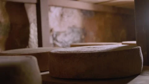 Serra da Canastra Cheese that is being cured in a cellar with rag envolved Stock Footage 258684132