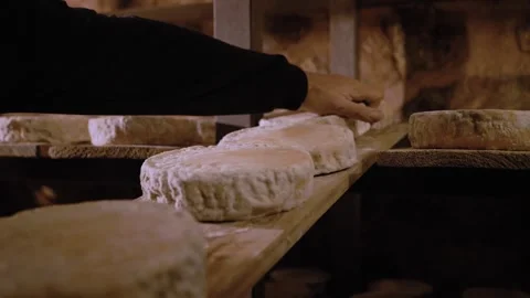 Serra da Canastra cheese being cured in a cave, being turned by a local producer Stock Footage 258684332