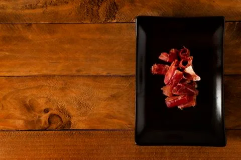 Serrano ham chips on a plate. Stock Photos