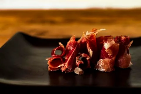 Serrano ham chips on a plate. Stock Photos