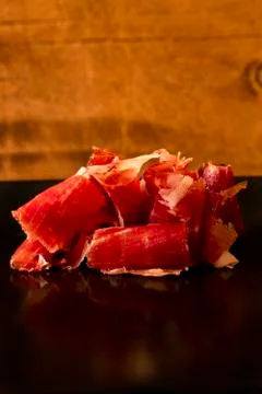 Serrano ham chips on a plate. Photos