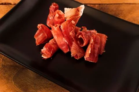 Serrano ham chips from Spain. Stock Photos