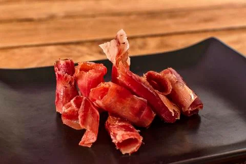 Serrano ham chips from Spain. Stock Photos