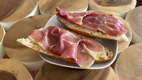 Serrano ham toast with olive oil rotating on turntable Stock Footage 333597109