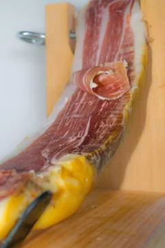 Serrano ham on wooden surface Stock Photos