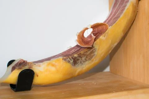 Serrano ham on wooden surface Stock Photos