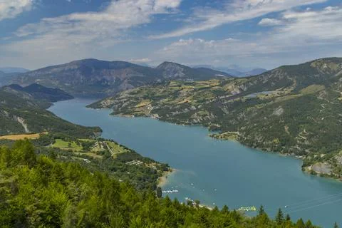 Serre Poncon Lake Embraced by Lush Green Mountains in French Alps under Sum.. Stock Photos