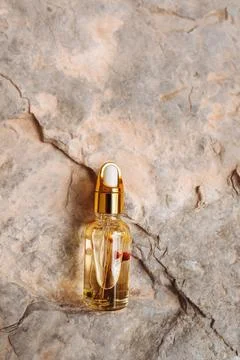 Serum bottle dropper on stone surface Stock Photos