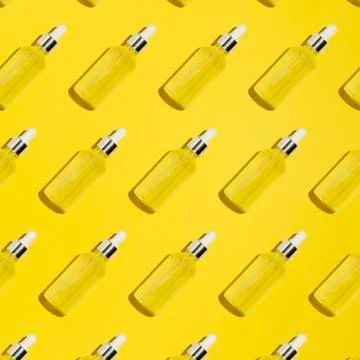 Serum bottle pattern on yellow background Stock Photos