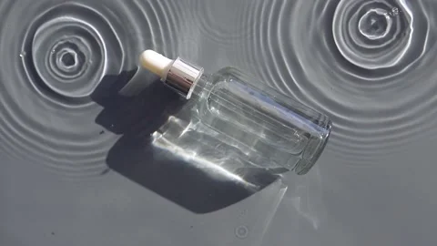 Serum bottle in water with falling drops Stock Footage 197541687
