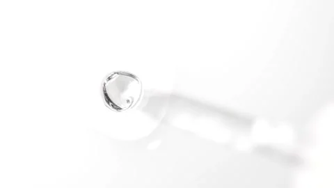 Serum drops falling from a pipette, macro. Cosmetics bubbles texture. Stock Footage 305074106