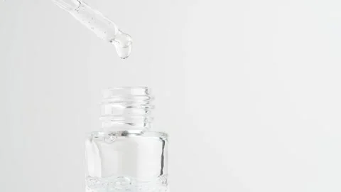 Serum gel in pipette falling in the bottle. Close up of pipette and the tra.. Stock Footage 259281148