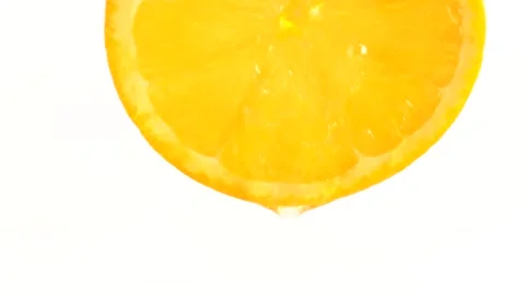 Serum with vitamin C flows down from orange on white background. Anti age c.. Stock Footage 273677999