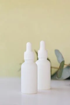 Serum in a white bottle on a light background. Aromatherapy oil, natural Stock Photos