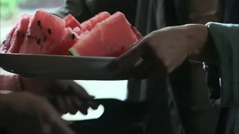 The servant places the watermelon for the master Stock Footage 261640525