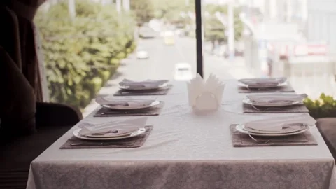 Servated table in a restaurant against the background of the street Видео 159140121