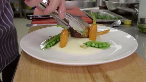 Serve the dish before serving in the restaurant. Meat steak with vegetables and Stock Footage 74718911