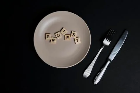 To serve a protest concept. Word protest on a dish Stock Photos