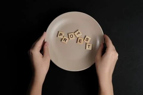 To serve a protest concept. Word protest on a dish Stock Photos