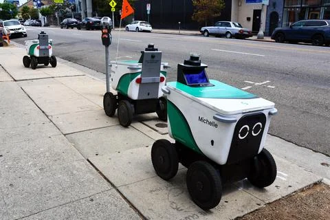 Serve Robotics autonomous delivery robots parked on a city sidewalk Stock Photos
