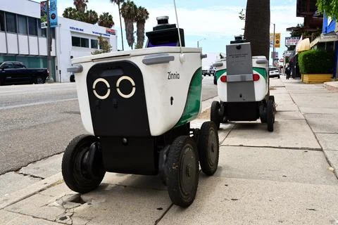 Serve Robotics autonomous delivery robots parked on a city sidewalk Stock Photos