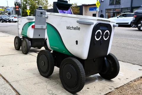 Serve Robotics autonomous delivery robots parked on a city sidewalk Stock Photos