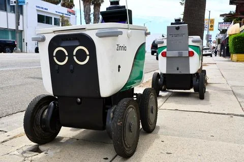 Serve Robotics autonomous delivery robots parked on a city sidewalk Stock Photos