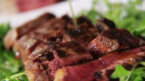 Serve steak slices:putting extra virgin olive oil over sliced beef Stock Footage 61356622