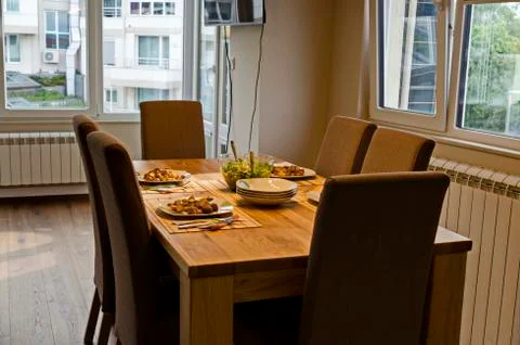 Served appetizing dinner of fried potatoes and green salad on a table Stock Photos