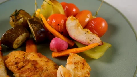 Served baked cooked vegetables with chicken meat slices on plate, close-up view. Stock Footage 312464743