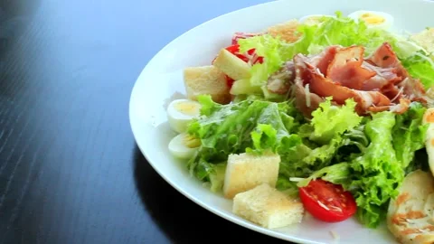 Served Caesar salad with fresh ingredients on a large salad plate Stock Footage 321243483