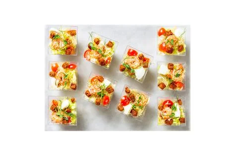 Served Caesar salad with prawns in a plastic boxes, catering food Stock Photos