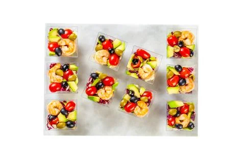 Served Caesar salad with shrips in a plastic boxes, catering food Stock Photos