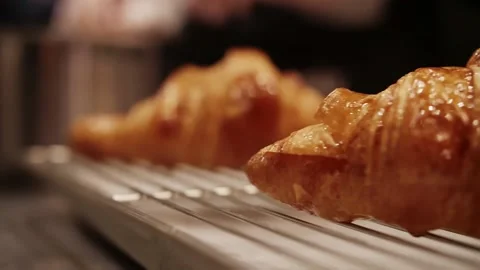 Served croissants are placed on the table.Croissant Cooking Process Stock Footage 208631177