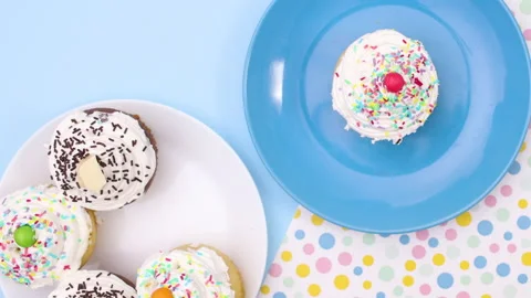 Served cup cakes on plate on the table moving. stop motion Stock Footage 148737865