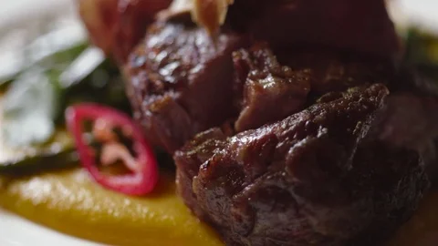 Served dish, meat, sauce and vegetables on the white plate. Junk food. Stock Footage 74623903