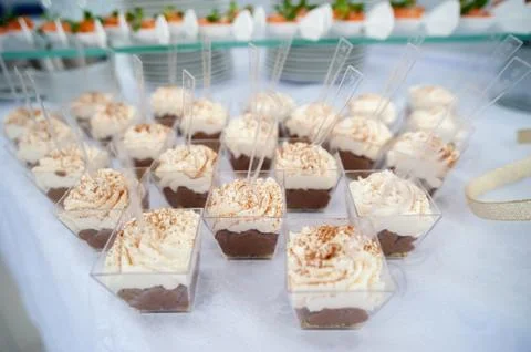 Served festive candy bar table with cupcakes tower and love is sweet sign Stock Photos