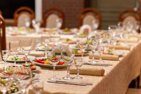 Served festive table with snacks, glasses, glasses, cutlery and napkins for.. Фото
